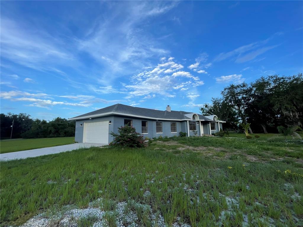 755 South Narcoossee Road St. Cloud, FL 34771 - Photo 4 of 44 a view of house with yard and green space
