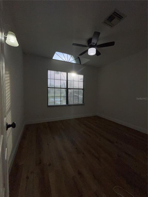 755 South Narcoossee Road St. Cloud, FL 34771 - Photo 42 of 44 an empty room with wooden floor fan and windows