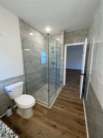 a bathroom with a toilet and a shower