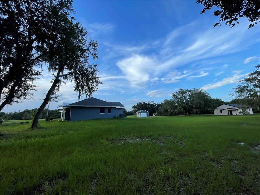755 South Narcoossee Road St. Cloud, FL 34771 - Photo 5 of 44 a backyard of a house with lots of green space