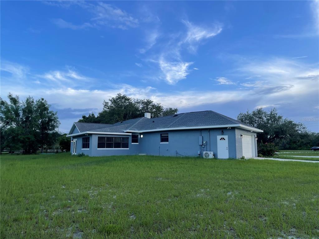 755 South Narcoossee Road St. Cloud, FL 34771 - Photo 6 of 44 a view of a house with a big yard