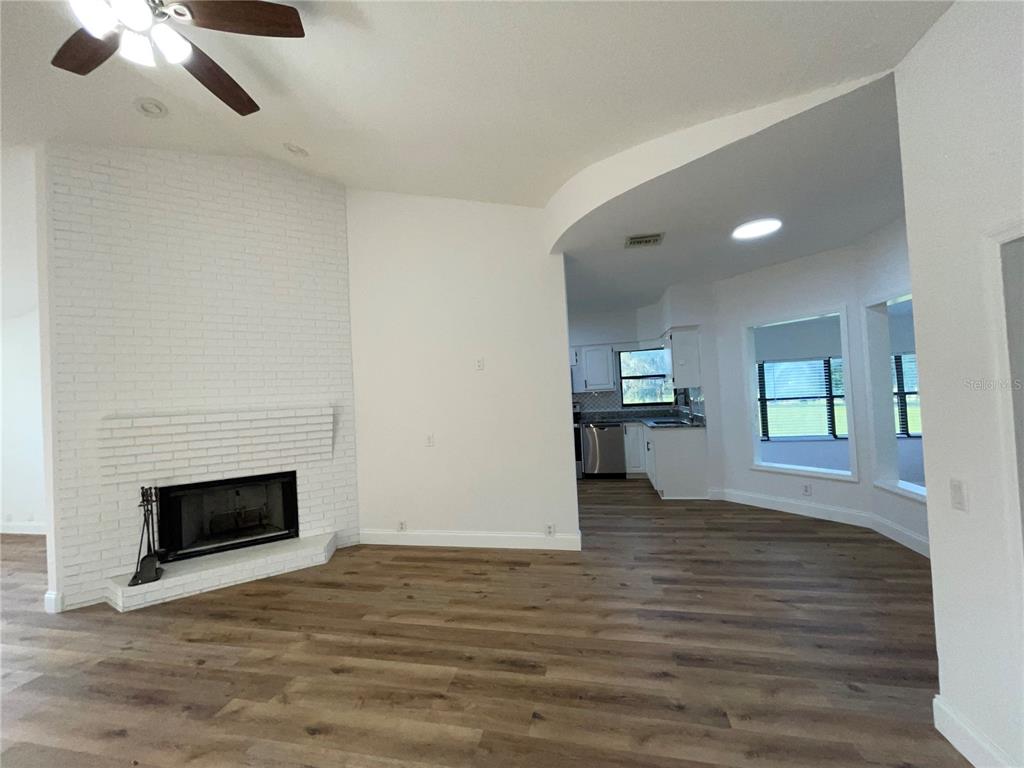 755 South Narcoossee Road St. Cloud, FL 34771 - Photo 7 of 44 a view of empty room with wooden floor and fireplace