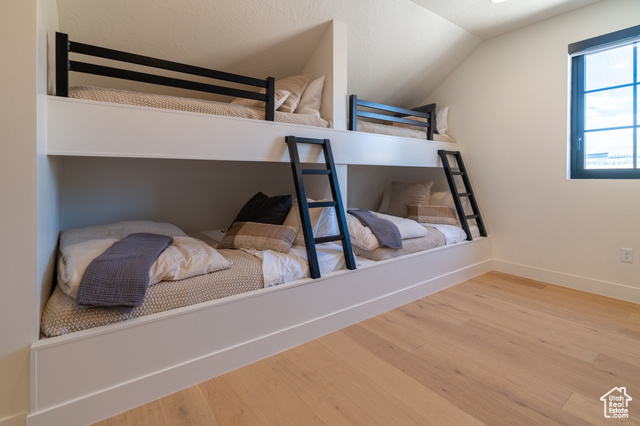 5366 Cyan Lane St. George, UT 84790 - Photo 31 of 39 Bedroom featuring wood finished floors and vaulted ceiling