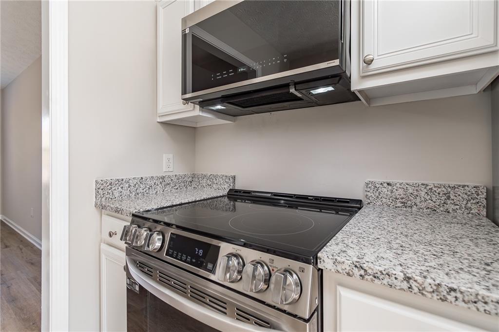 5014 Red Oak Lane Gainesville, GA 30506 - Photo 18 of 43 a stove top oven sitting inside of a kitchen