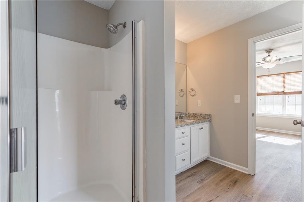 5014 Red Oak Lane Gainesville, GA 30506 - Photo 26 of 43 a spacious bathroom with a granite countertop sink a mirror and a shower