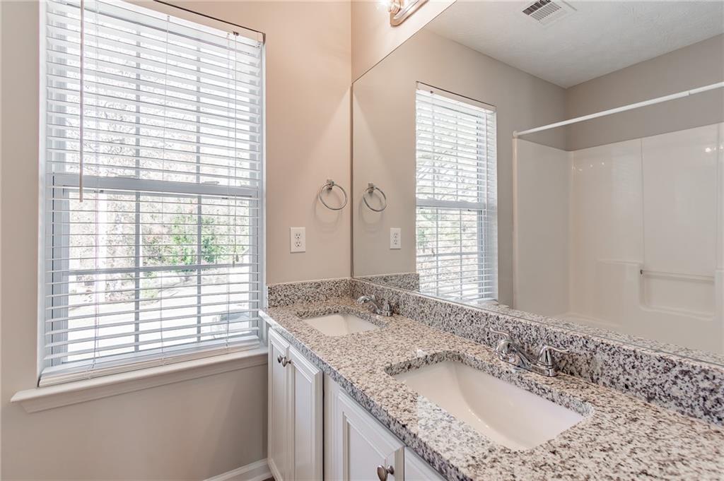 5014 Red Oak Lane Gainesville, GA 30506 - Photo 30 of 43 a bathroom with a granite countertop sink and a large mirror