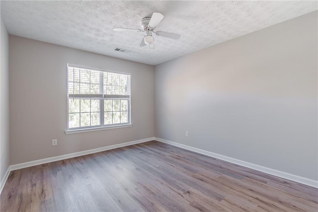 5014 Red Oak Lane Gainesville, GA 30506 - Photo 32 of 43 an empty room with wooden floor and windows