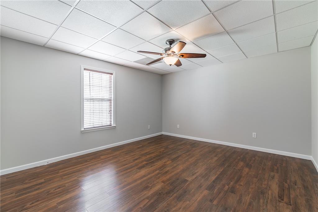 5014 Red Oak Lane Gainesville, GA 30506 - Photo 38 of 43 an empty room with wooden floor fan and windows