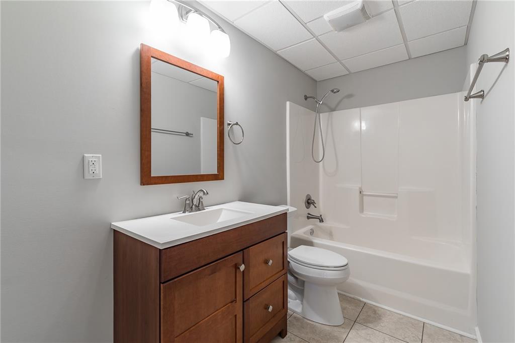 5014 Red Oak Lane Gainesville, GA 30506 - Photo 40 of 43 a bathroom with a toilet a sink and a mirror