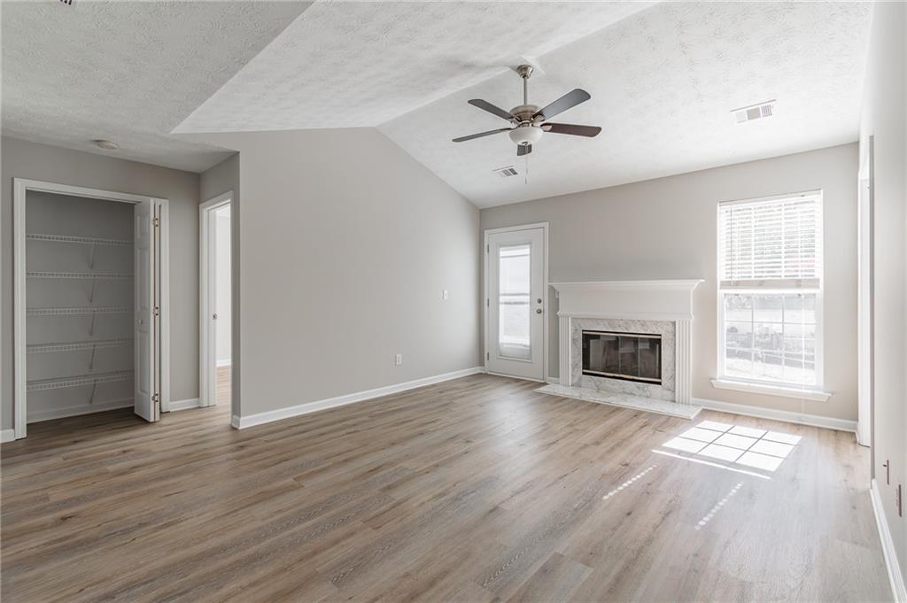 5014 Red Oak Lane Gainesville, GA 30506 - Photo 10 of 43 an empty room with wooden floor fan and windows
