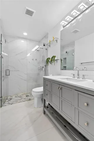 a bathroom with a sink toilet a shower and a mirror