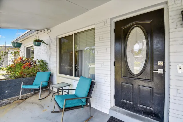 a view of an chairs and table in patio