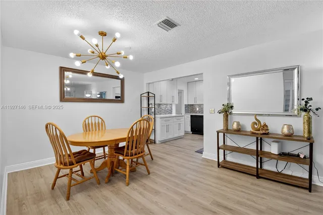 a living room with furniture fireplace and a chandelier
