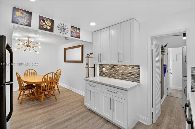a kitchen with stainless steel appliances granite countertop a refrigerator and a stove top oven