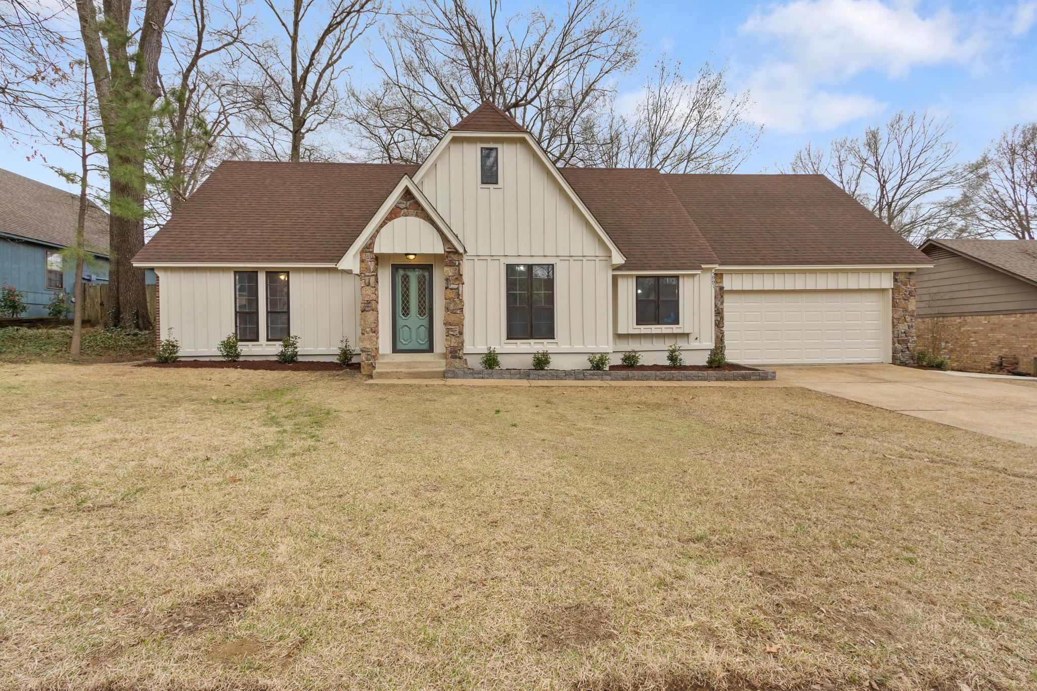 Modern farmhouse style home with board and batten siding, concrete driveway, roof with shingles, a front yard, and an attached garage