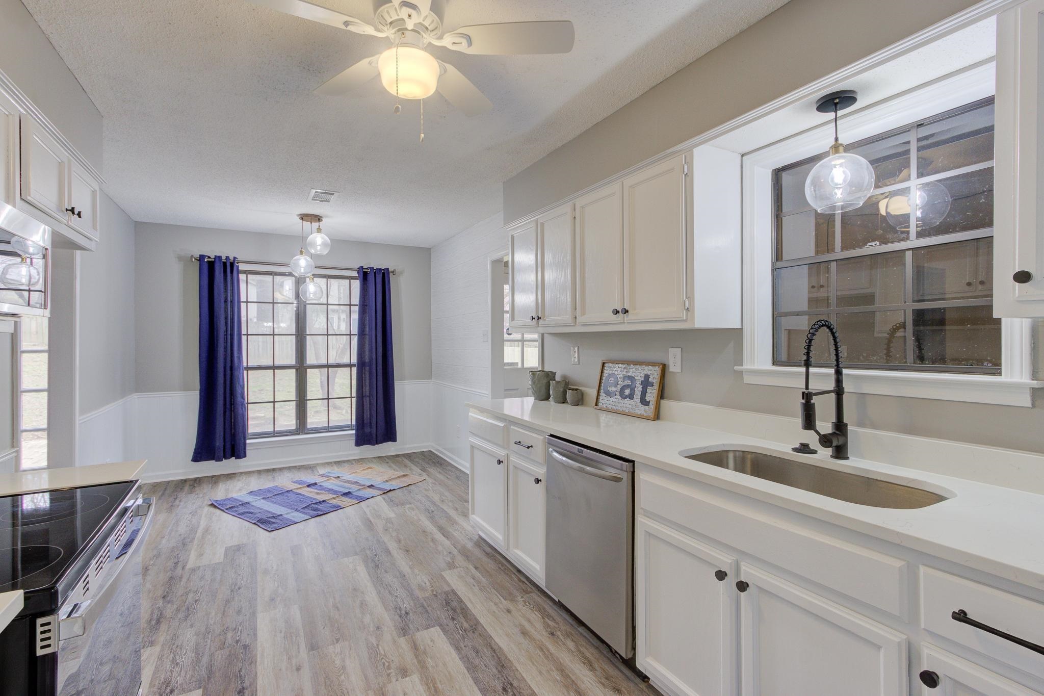 5991 Explorer Road Bartlett, TN 38134 - Photo 14 of 39 Kitchen with dishwasher, white cabinets, LVP floors, and undermount sink