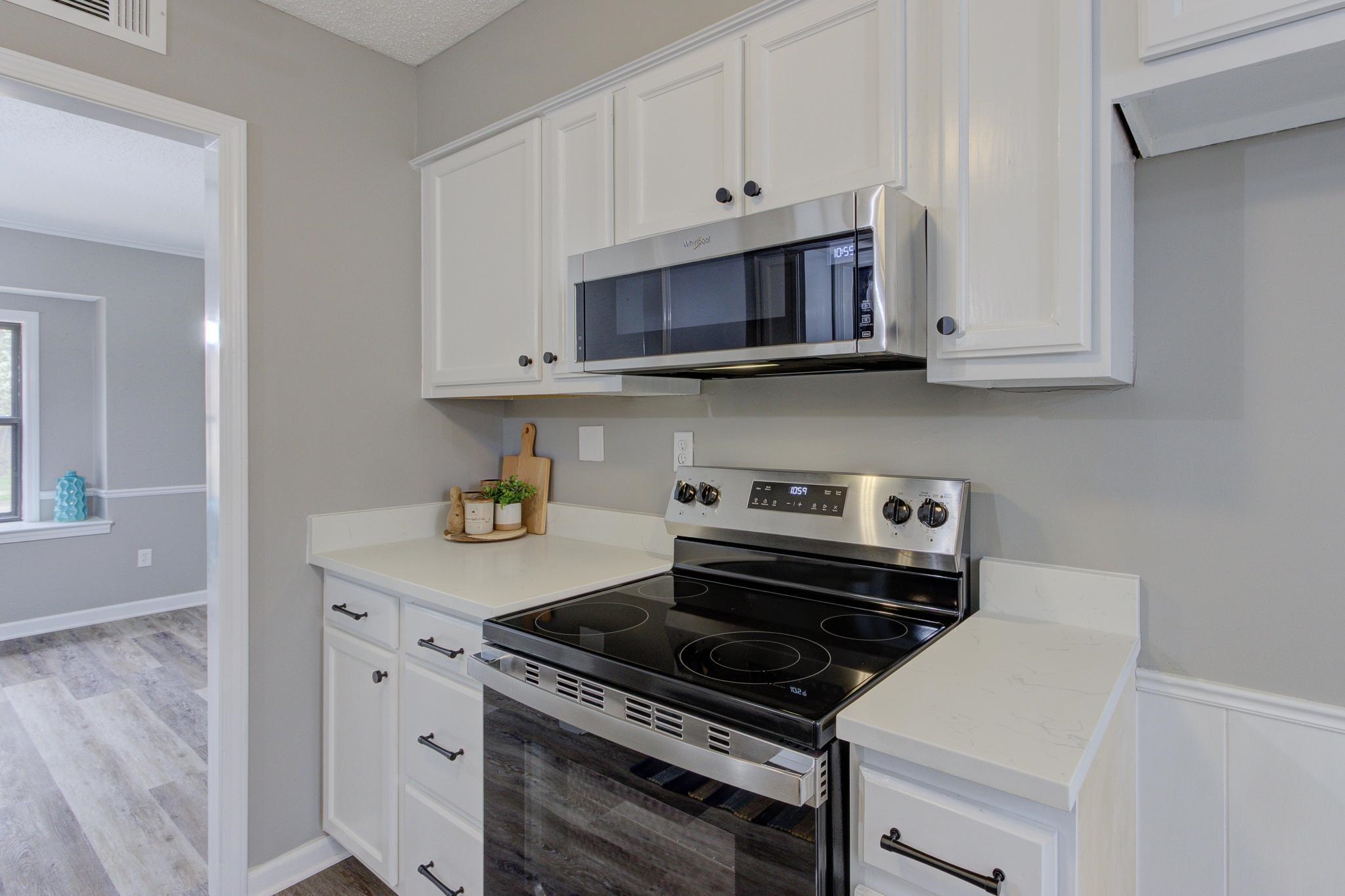 5991 Explorer Road Bartlett, TN 38134 - Photo 16 of 39 Kitchen featuring new stainless steel stove and microwave. Quartz countertops.