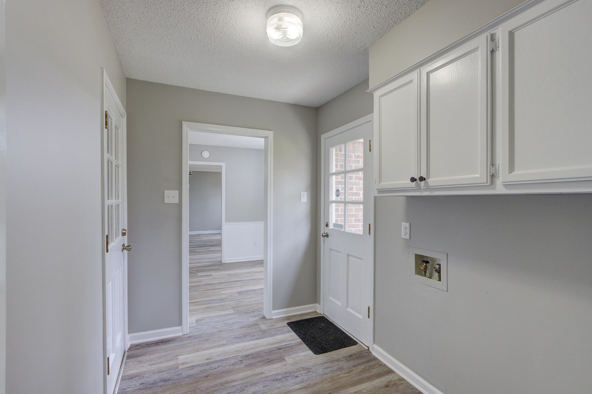 5991 Explorer Road Bartlett, TN 38134 - Photo 19 of 39 Laundry room with doorway from garage and doorway to outside back yard.