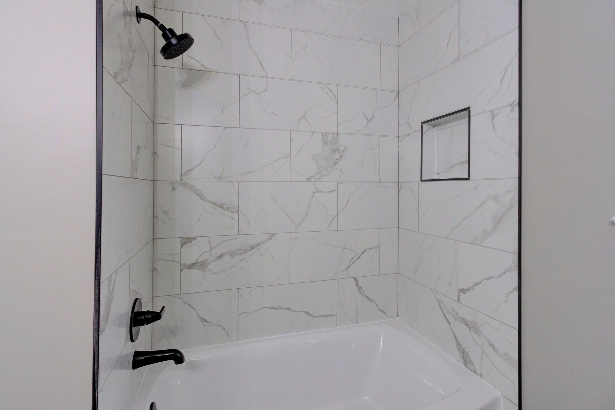 5991 Explorer Road Bartlett, TN 38134 - Photo 26 of 39 Bathroom featuring shower/tub combination, matte black finishes, Statuario Matte Porcelain tile