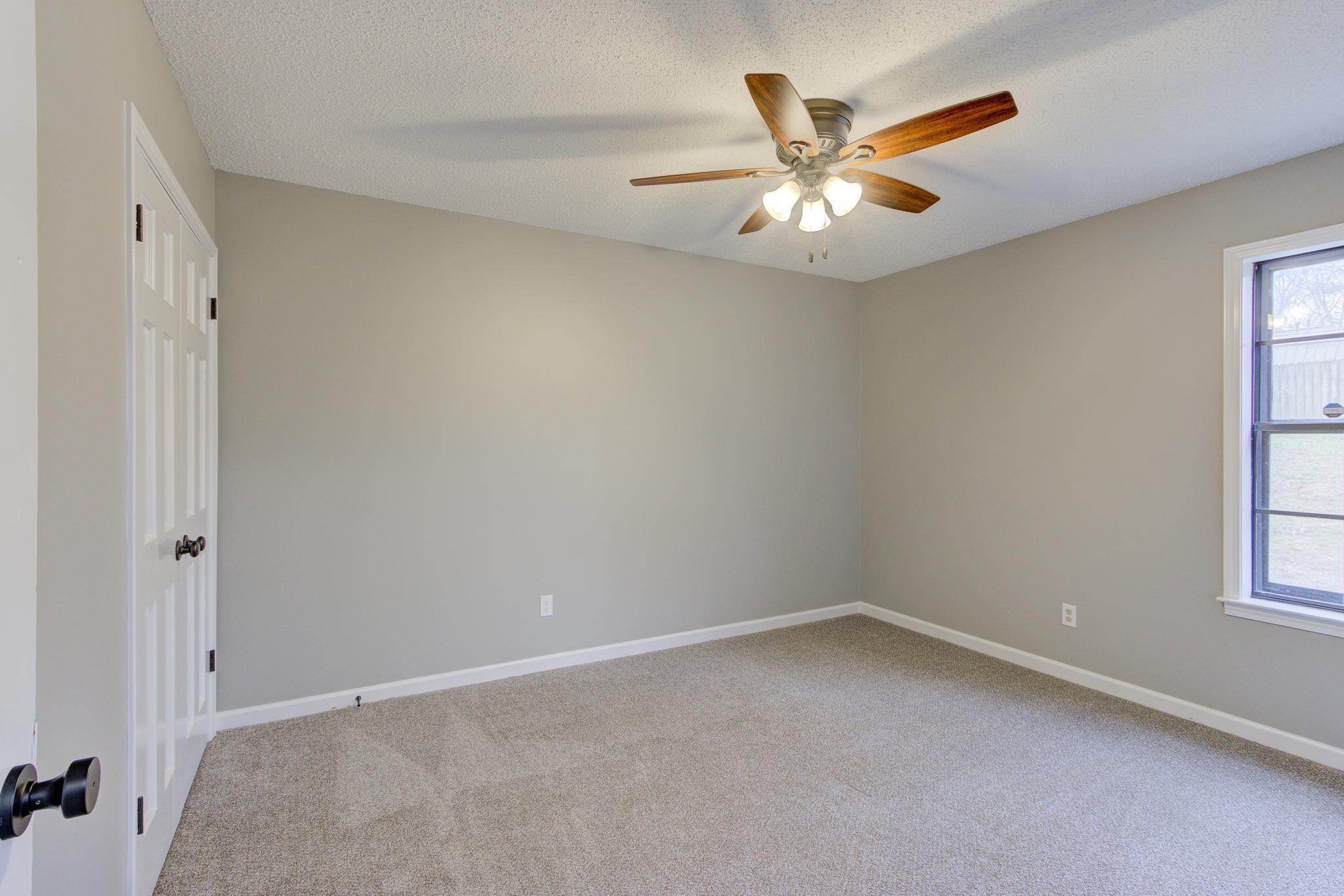 5991 Explorer Road Bartlett, TN 38134 - Photo 27 of 39 1st bedroom downstairs, with baseboards, new carpet and a ceiling fan