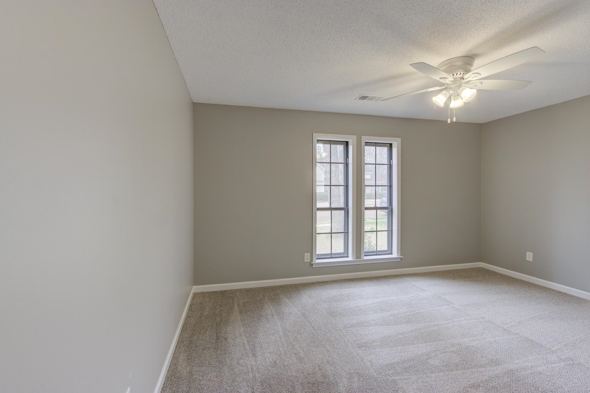 5991 Explorer Road Bartlett, TN 38134 - Photo 28 of 39 2nd bedroom downstairs, with baseboards, new carpet and a ceiling fan