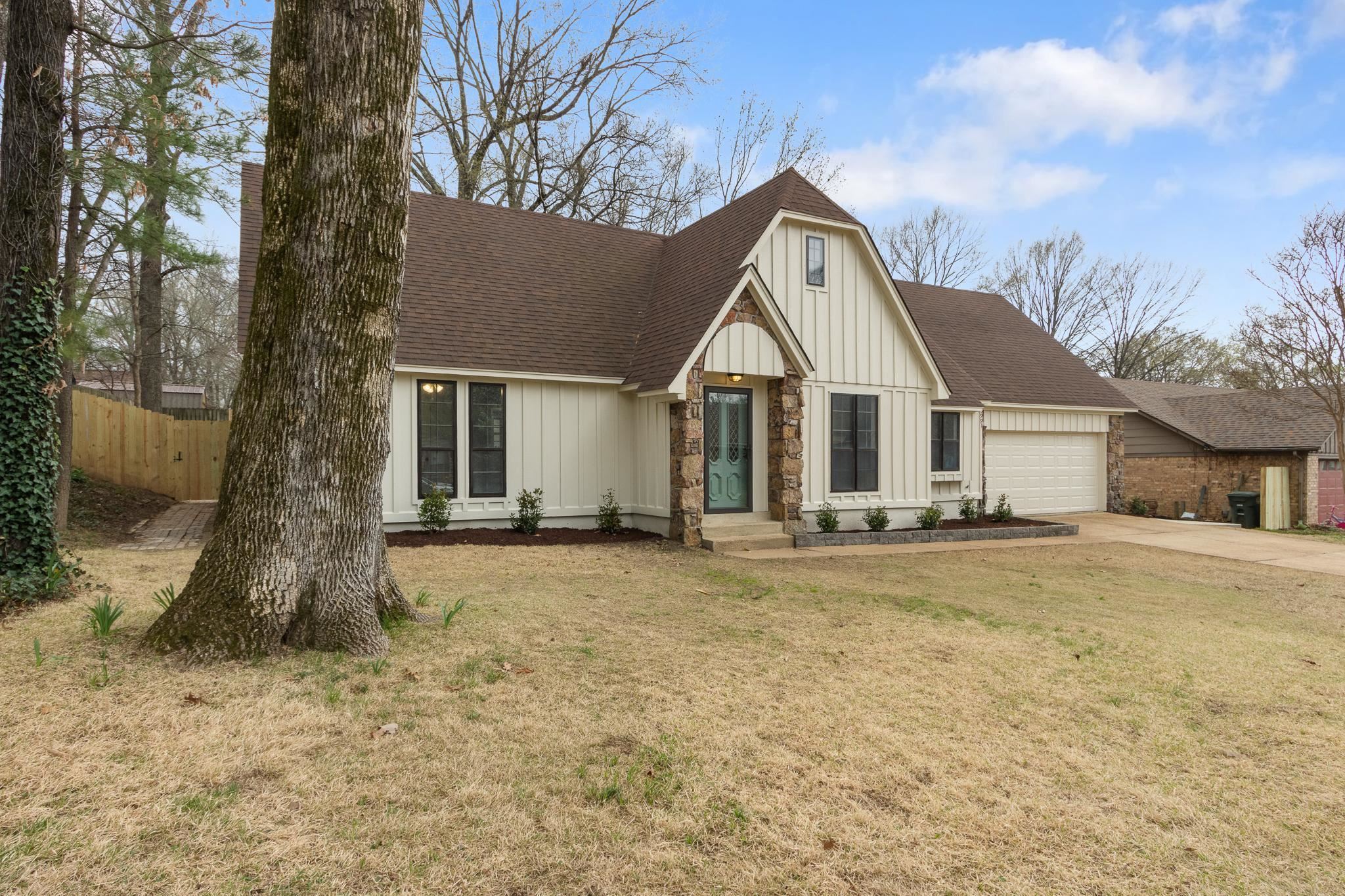 5991 Explorer Road Bartlett, TN 38134 - Photo 4 of 39 Modern farmhouse featuring driveway, fence, a front yard, a shingled roof, and a garage