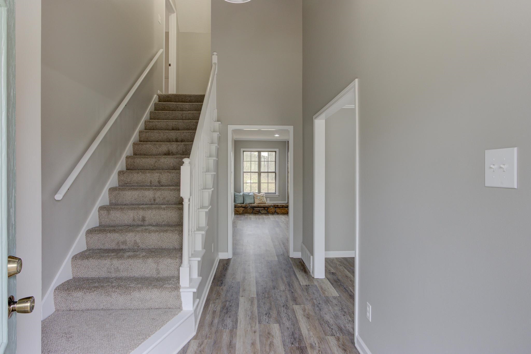 5991 Explorer Road Bartlett, TN 38134 - Photo 5 of 39 Staircase with a towering ceiling, baseboards, and LVP & Carpet floors