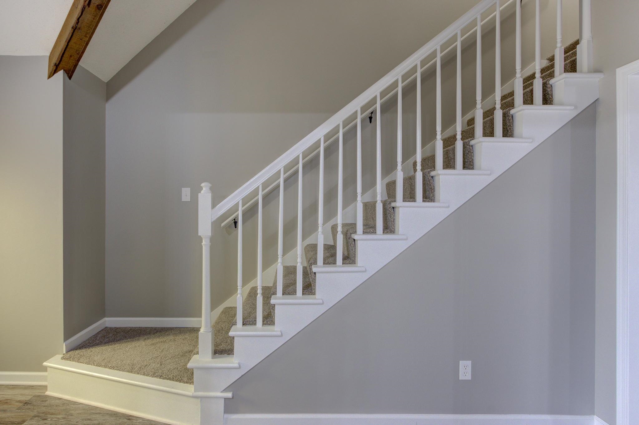 5991 Explorer Road Bartlett, TN 38134 - Photo 9 of 39 Stairway with beam ceiling, high vaulted ceiling, and baseboards