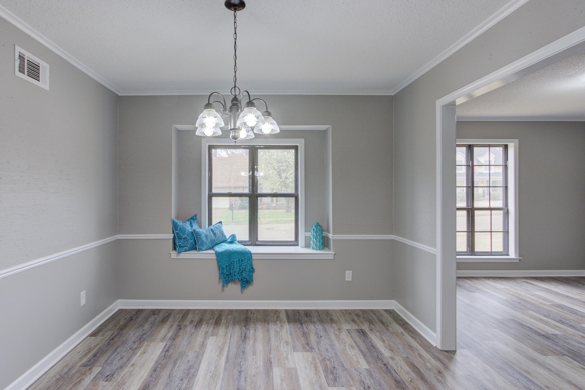 5991 Explorer Road Bartlett, TN 38134 - Photo 10 of 39 Dinning room featuring LVP flooring, visible vents, baseboards, ornamental molding, and a notable chandelier