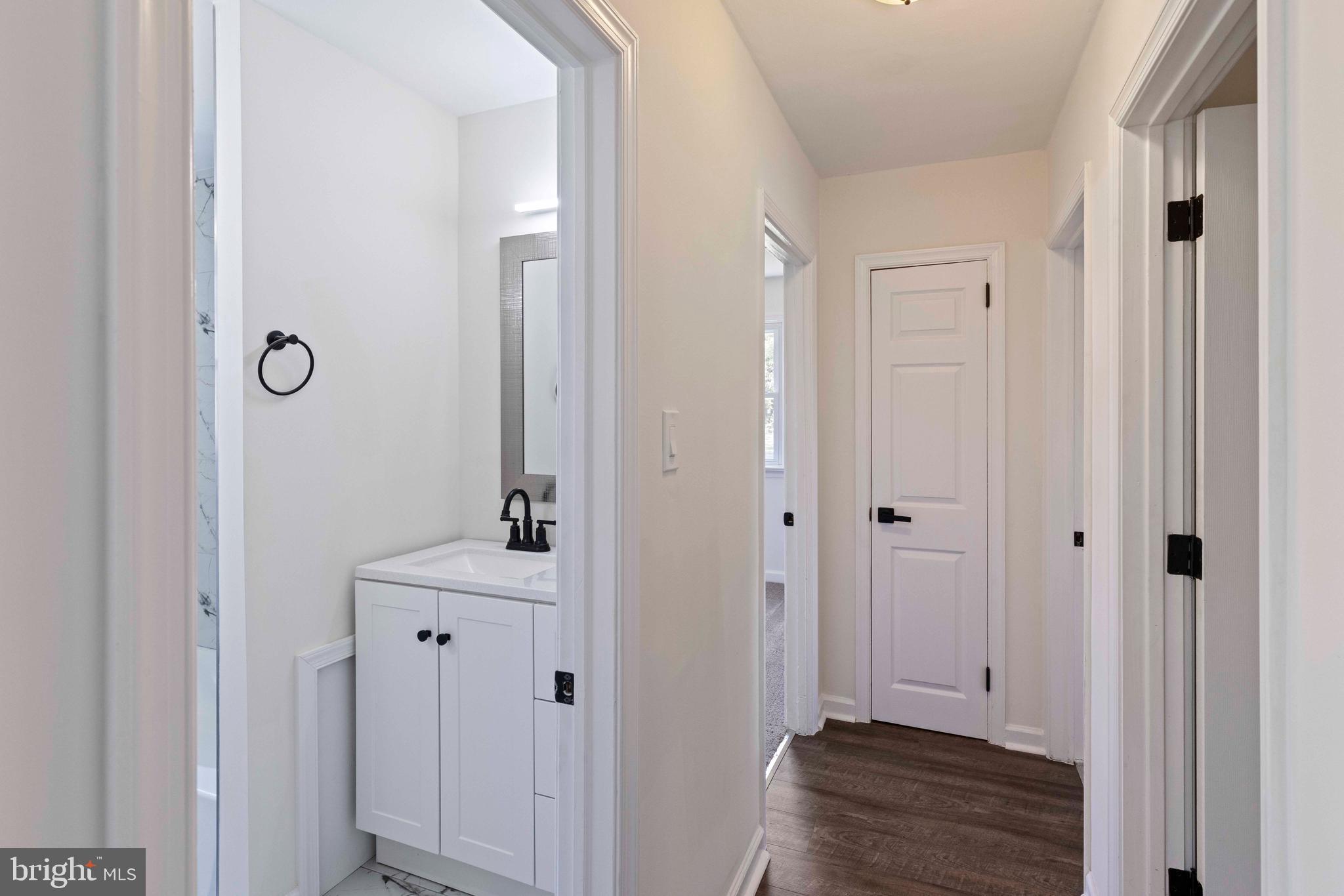 1210 Brownsville Road Langhorne, PA 19047 - Photo 6 of 13 a view of a bathroom with a sink mirror and wooden floor