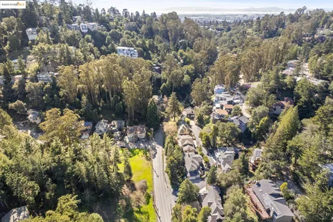 an aerial view of residential house with swimming pool and green space