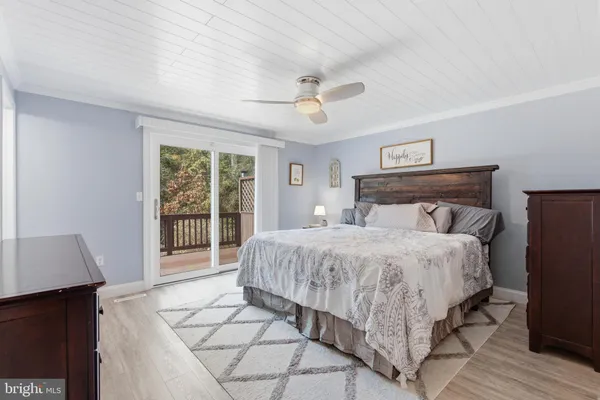 a bedroom with a bed and a night stand