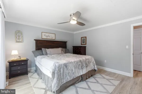 a bedroom with a large bed and a dresser