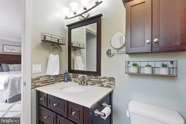 a bathroom with a sink toilet a mirror and shower
