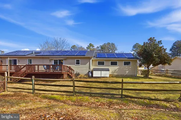 a yellow house with trees in front of it
