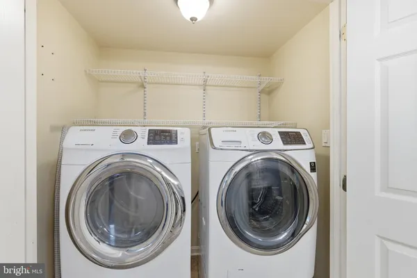 a bathroom with a granite countertop sink mirror vanity and toilet