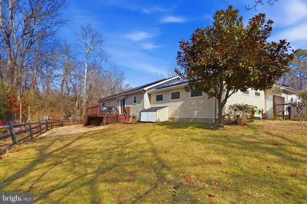 a view of a patio with a dining table and chairs with wooden floor