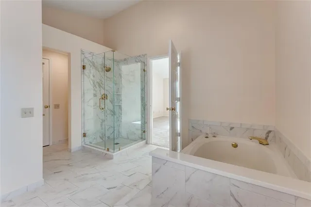 a bathroom with a bathtub and shower