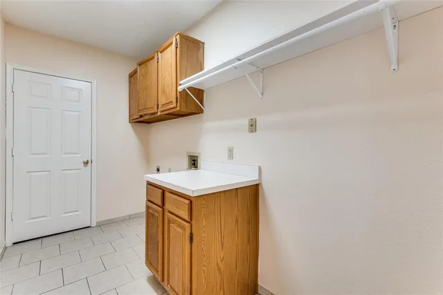 a kitchen with a sink cabinets and a stove top oven