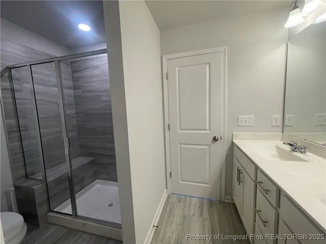 a bathroom with a shower sink and toilet