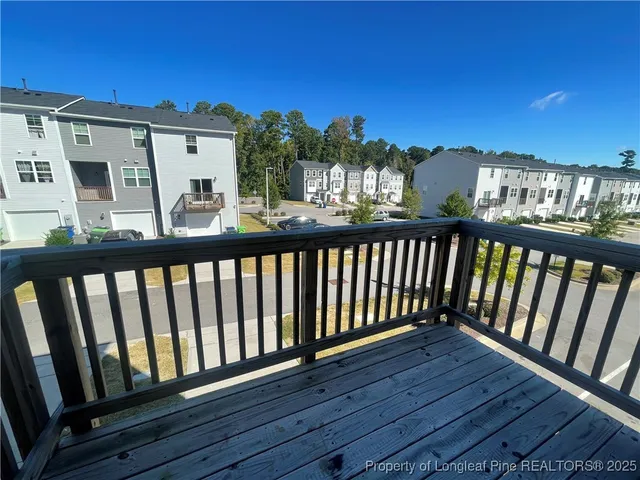 a view of a balcony with wooden floor and outdoor space