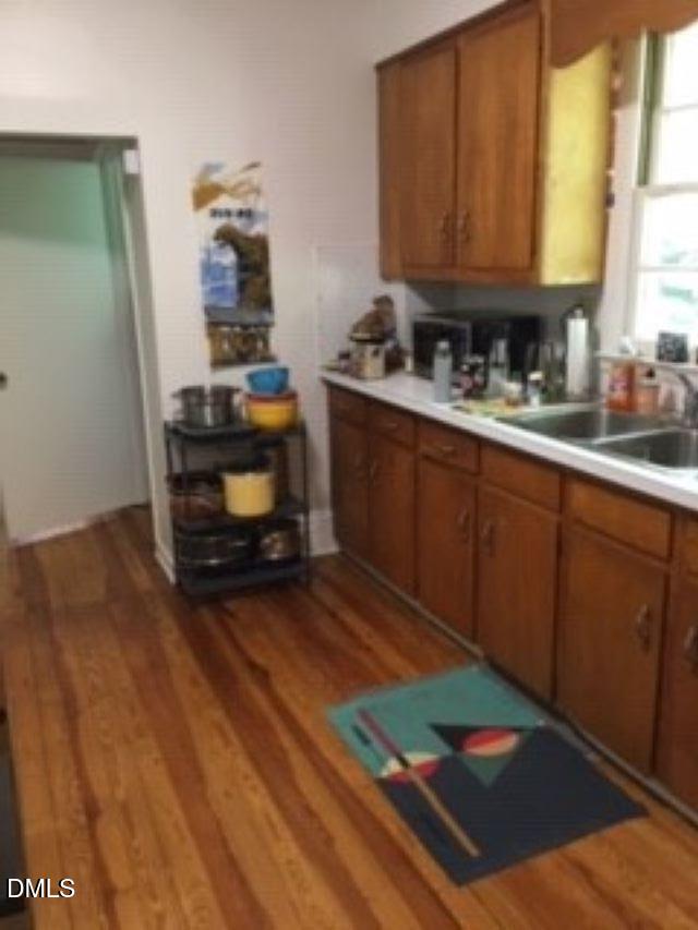 503 Cole Street, Unit 1/2 Raleigh, NC 27605 - Photo 11 of 35 a kitchen with granite countertop wooden cabinets and a stove