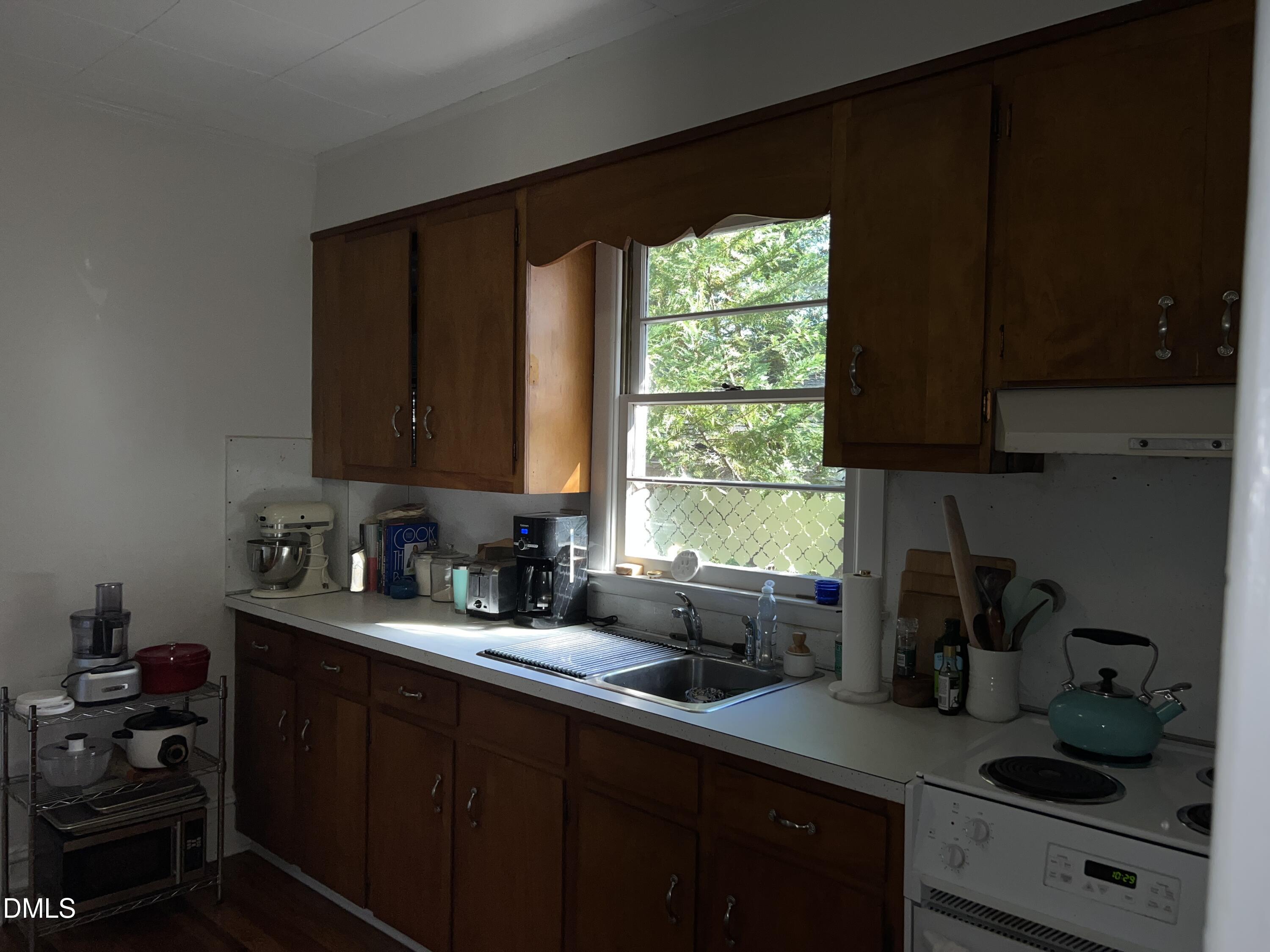 503 Cole Street, Unit 1/2 Raleigh, NC 27605 - Photo 13 of 35 a kitchen with sink a window and cabinets