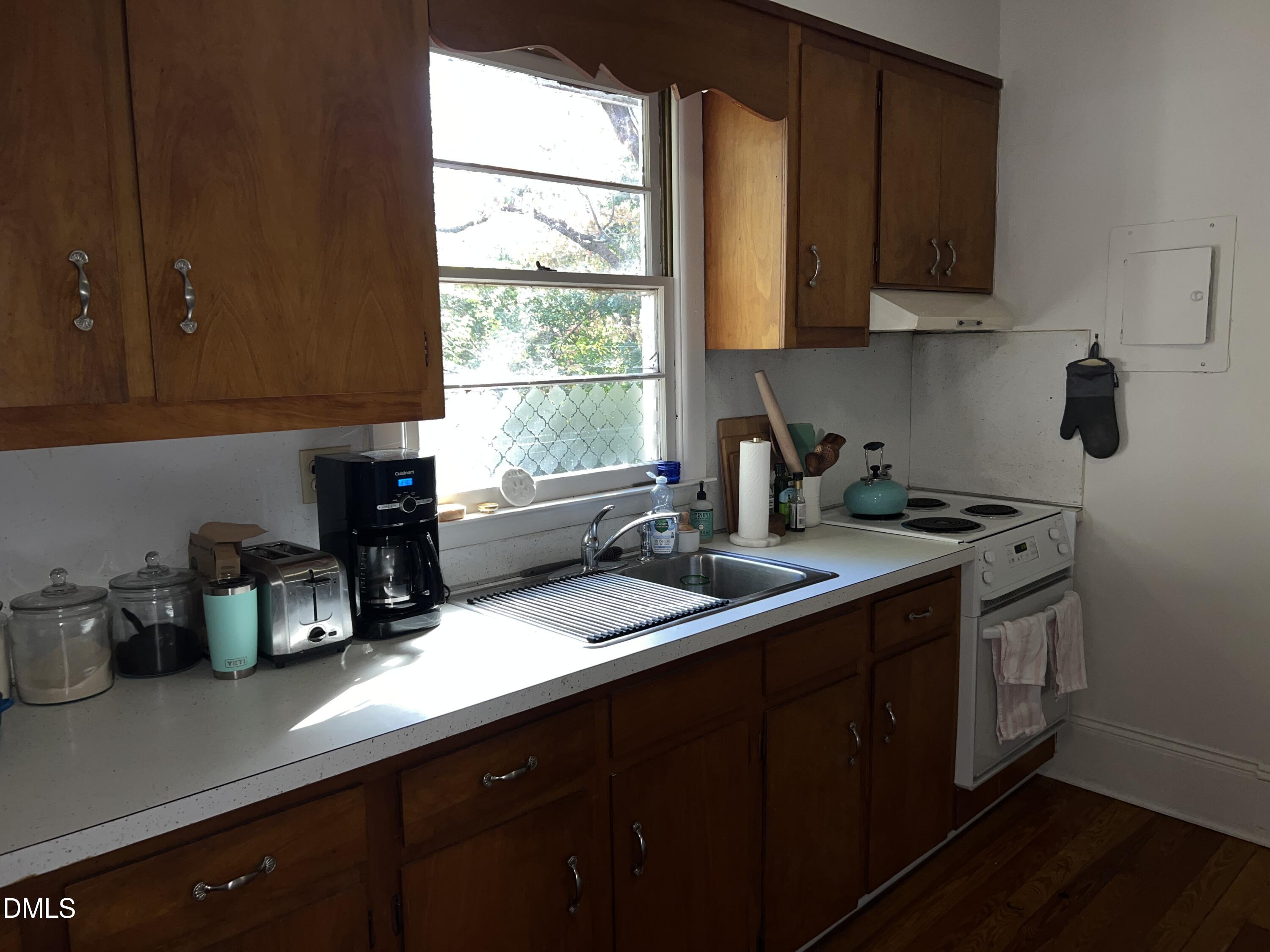 503 Cole Street, Unit 1/2 Raleigh, NC 27605 - Photo 14 of 35 a kitchen with a sink a window and cabinets