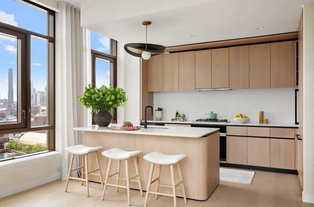 a kitchen with stainless steel appliances granite countertop a sink and a refrigerator