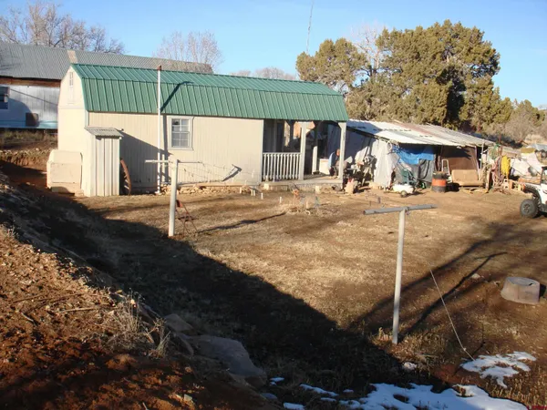 a view of a house with a backyard