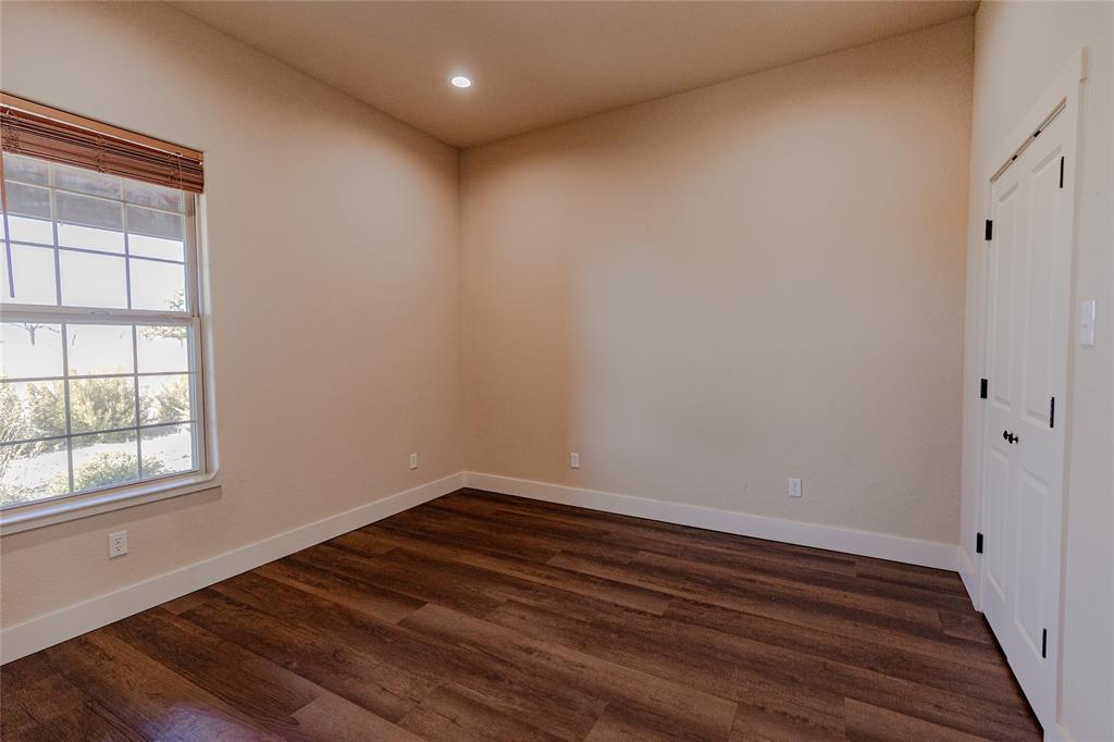 1433 County Road 1180 Decatur, TX 76234 - Photo 12 of 36 a room with wooden floor and window