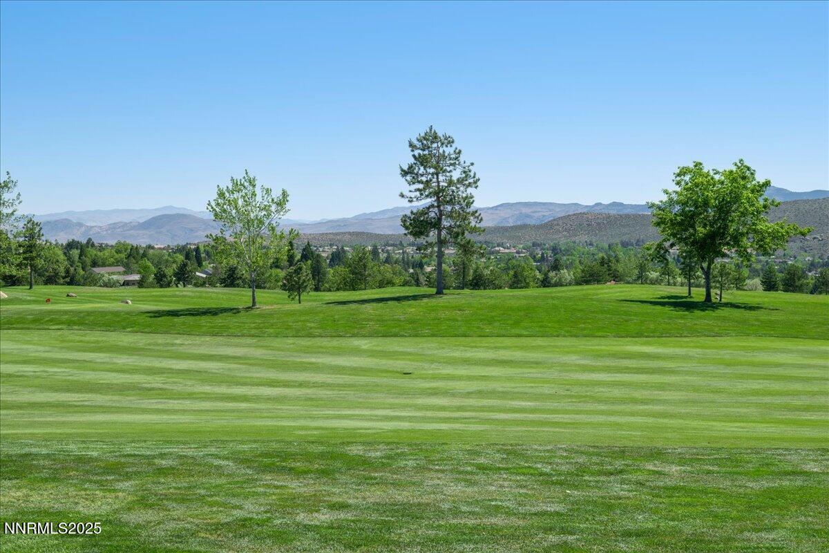 5605 Alpinista Circle Reno, NV 89511 - Photo 12 of 15 a grassy field with trees in the background