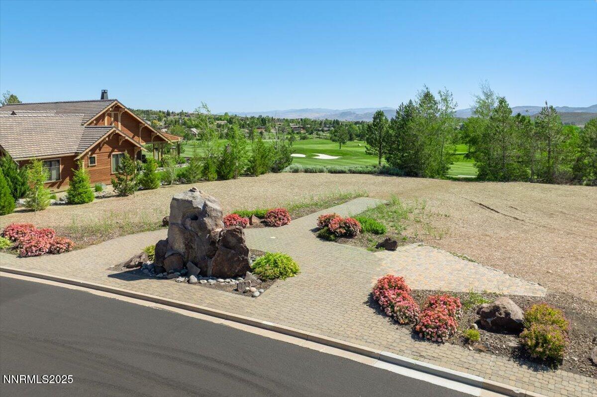 5605 Alpinista Circle Reno, NV 89511 - Photo 4 of 15 an aerial view of a house with a garden and mountain view