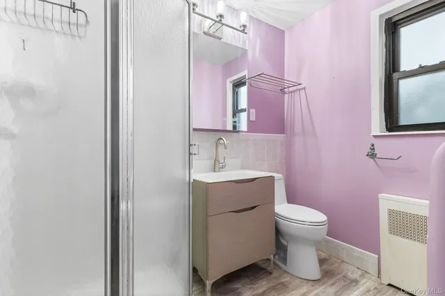 a bathroom with a sink toilet and mirror
